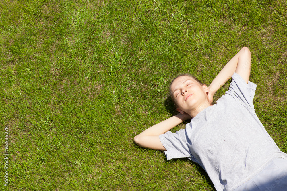 young girl lying on the grass