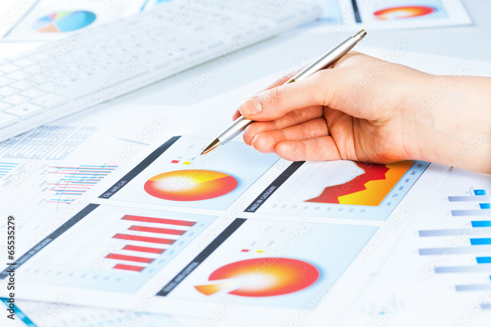 female hand pointing to the financial growth chart female hand pointing to the financial growth chart