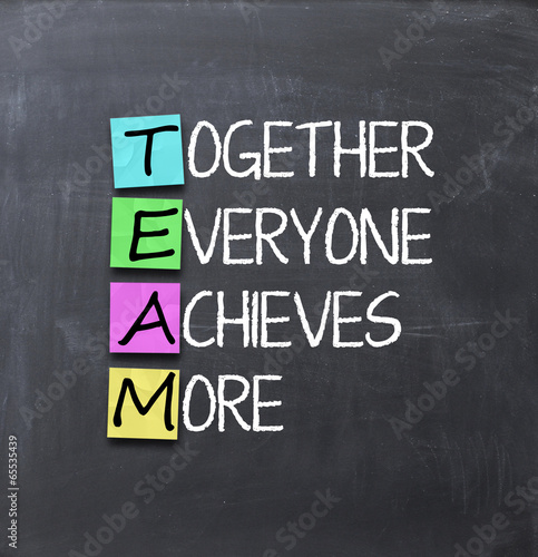 Teamwork concept with adehsive notes on blackboard
