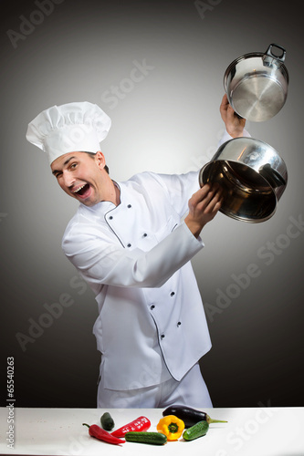Humorous portrait of a chef beating pots