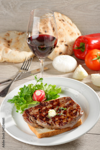 Grilled steak on toast bread and a glass of good wine