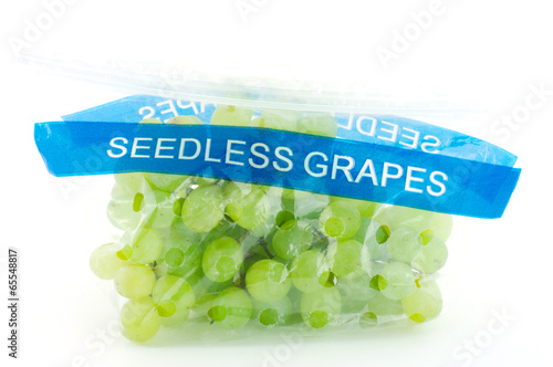 Seedless grapes in plastic bag isolated on white background.