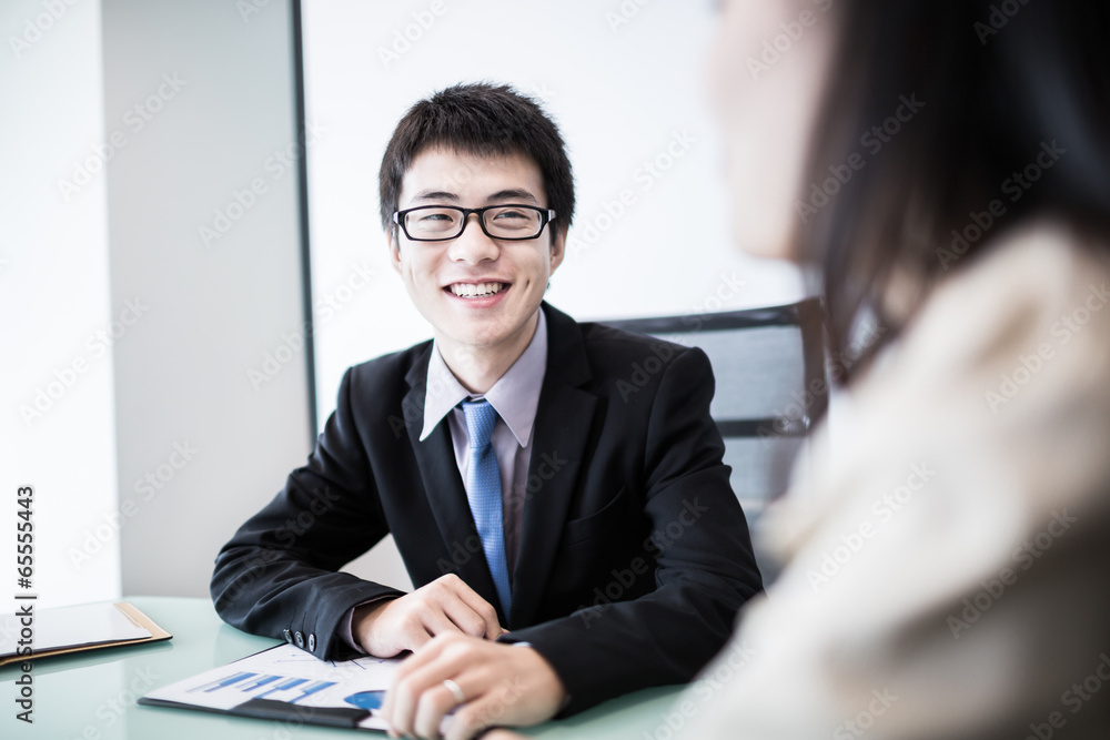 Successful young business executives meeting at the office Successful young business executives meeting at the office