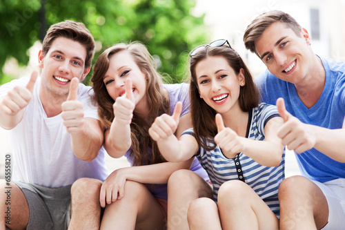 Young people with thumbs up