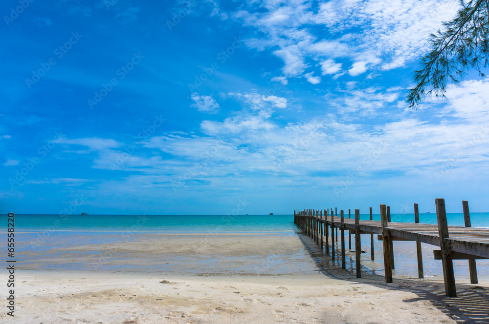 Wooden pier with blue sea and sky background Wooden pier with blue sea and sky background