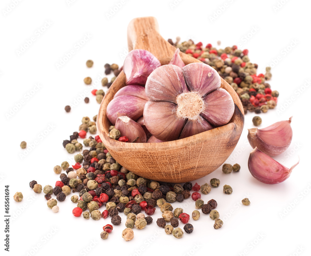 Garlic cloves in wooden bowl isolated on white background Garlic cloves in wooden bowl isolated on white background