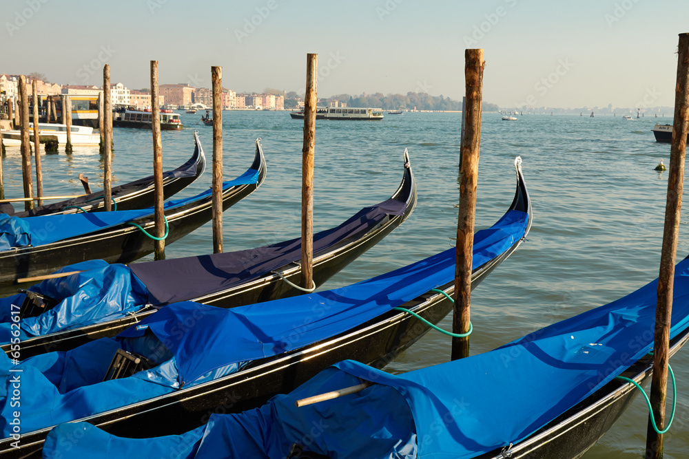 Venice gondolas pier with blue gondola in Italia