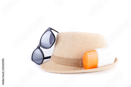 Hat , sunglasses , body lotion isolated on white background