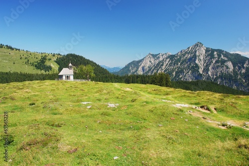 View of meadow with a church in Postalm, Austrian Alps
