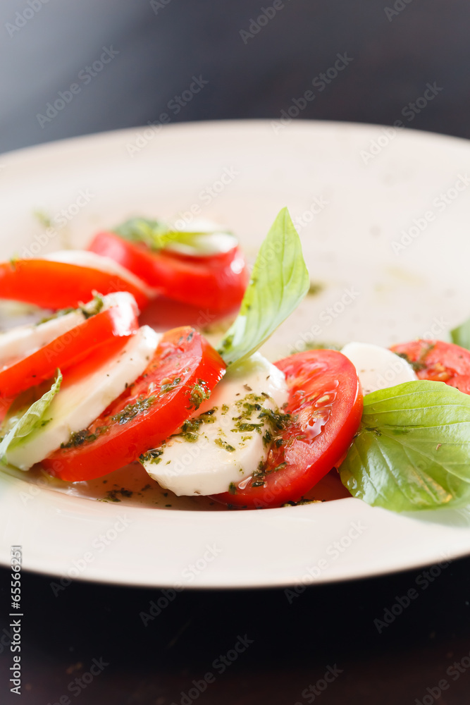 Tomato and mozzarella with basil leaves Tomato and mozzarella with basil leaves