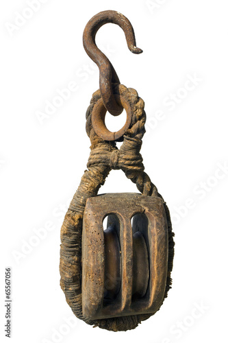 Wooden double pulley hanging on iron rusted hook