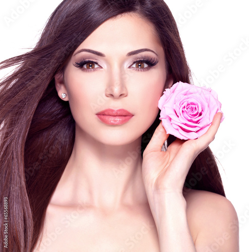 beautiful pretty woman with long hair and pink rose at face.