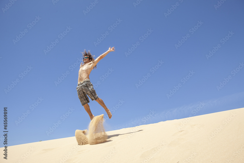 young man jumping happy in the desert young man jumping happy in the desert