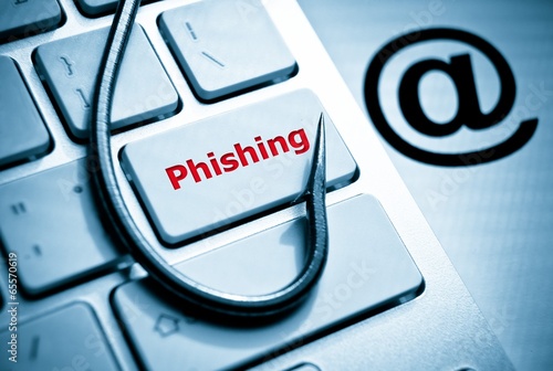phishing / fish hook on computer keyboard with email sign photo