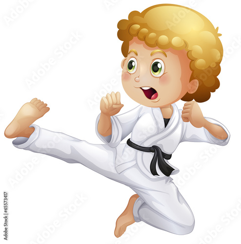 A cute little boy doing karate