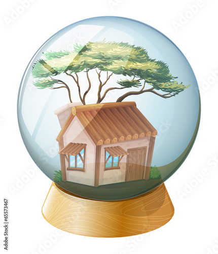 A crystal ball decor with a wooden house inside