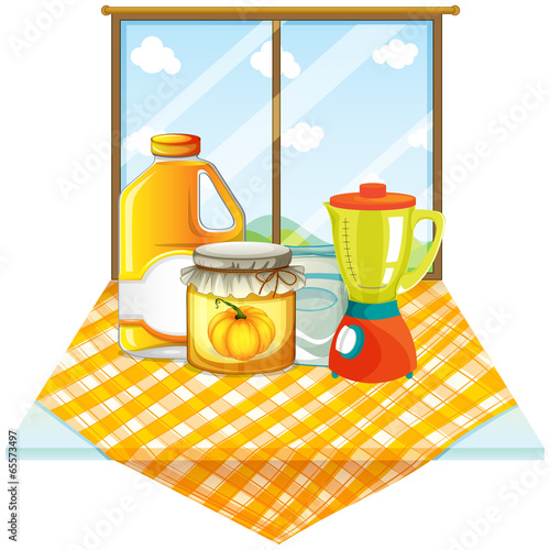 A table with a blender and containers
