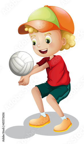 A young boy playing volleyball