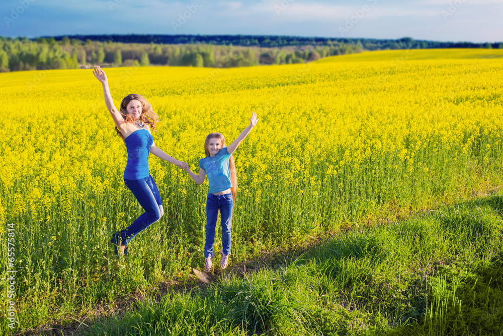 jumping women and girl in rape field