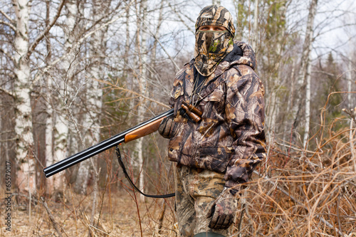 the hunter in camouflage with a gun