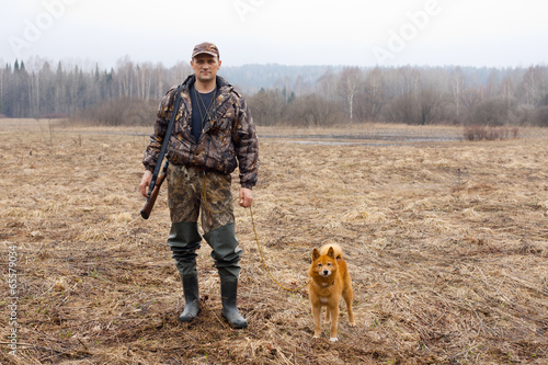 the hunter on the field with a dog
