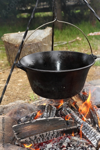 big metal pot on camp fire