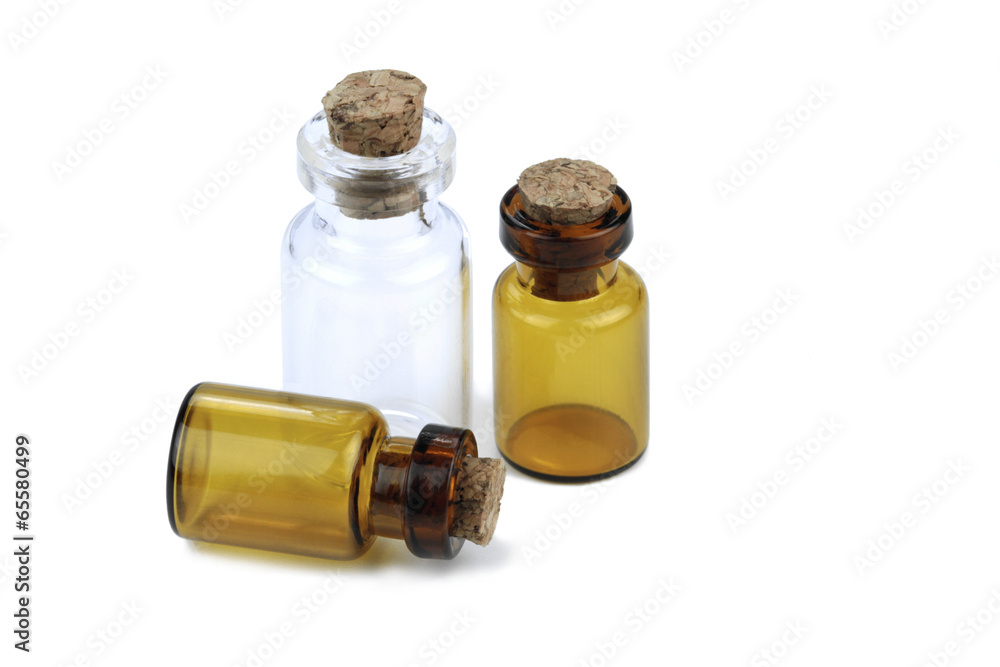 Small glass bottles with cork isolated on white background