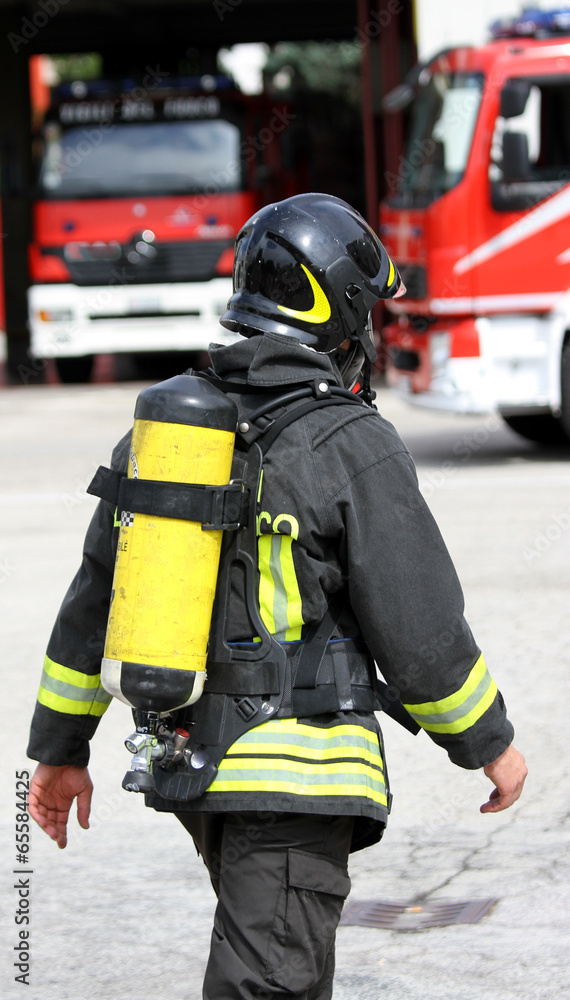 firefighter with yellow oxygen cylinder and the helmet firefighter with yellow oxygen cylinder and the helmet