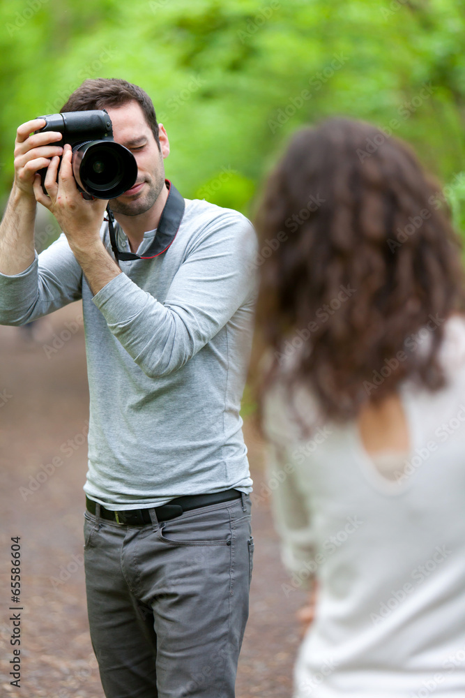 Photographer taking picture of an attractive model Photographer taking picture of an attractive model