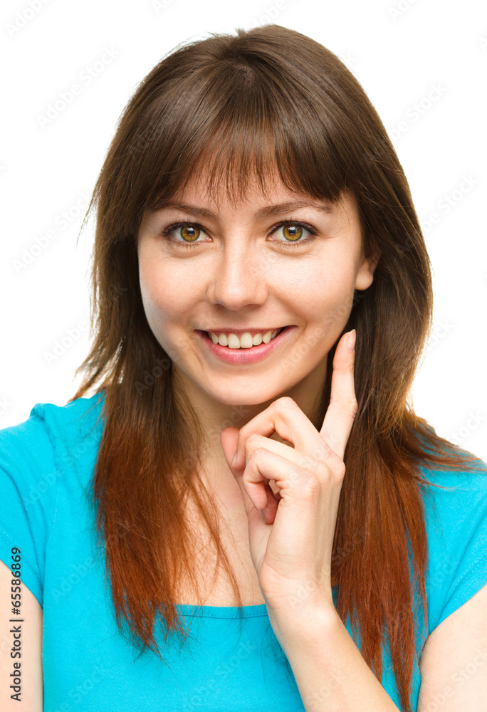 Fototapeta premium Young woman is supporting her head with hand