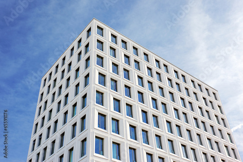 white multi-story building with light blue sky