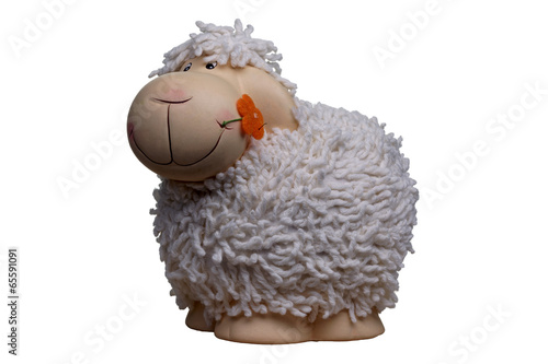porcelain and woolen toy sheep with orange flower in the mouth