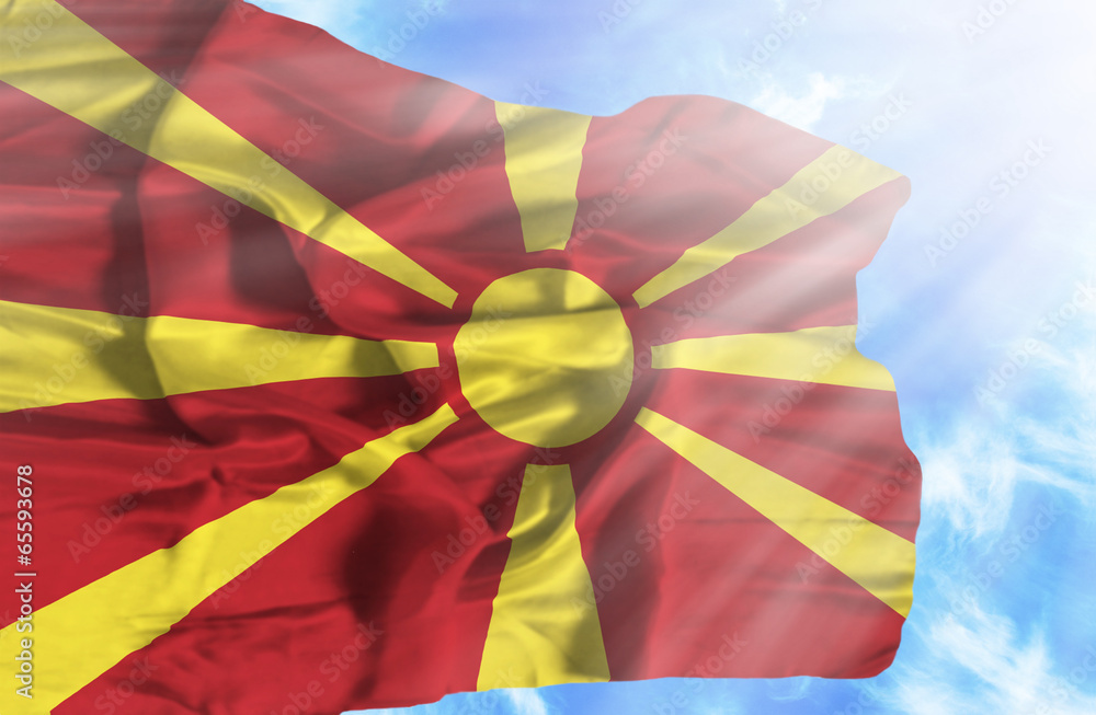 Macedonia waving flag against blue sky with sunrays