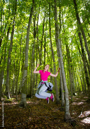 Cute little girl playing in a forest