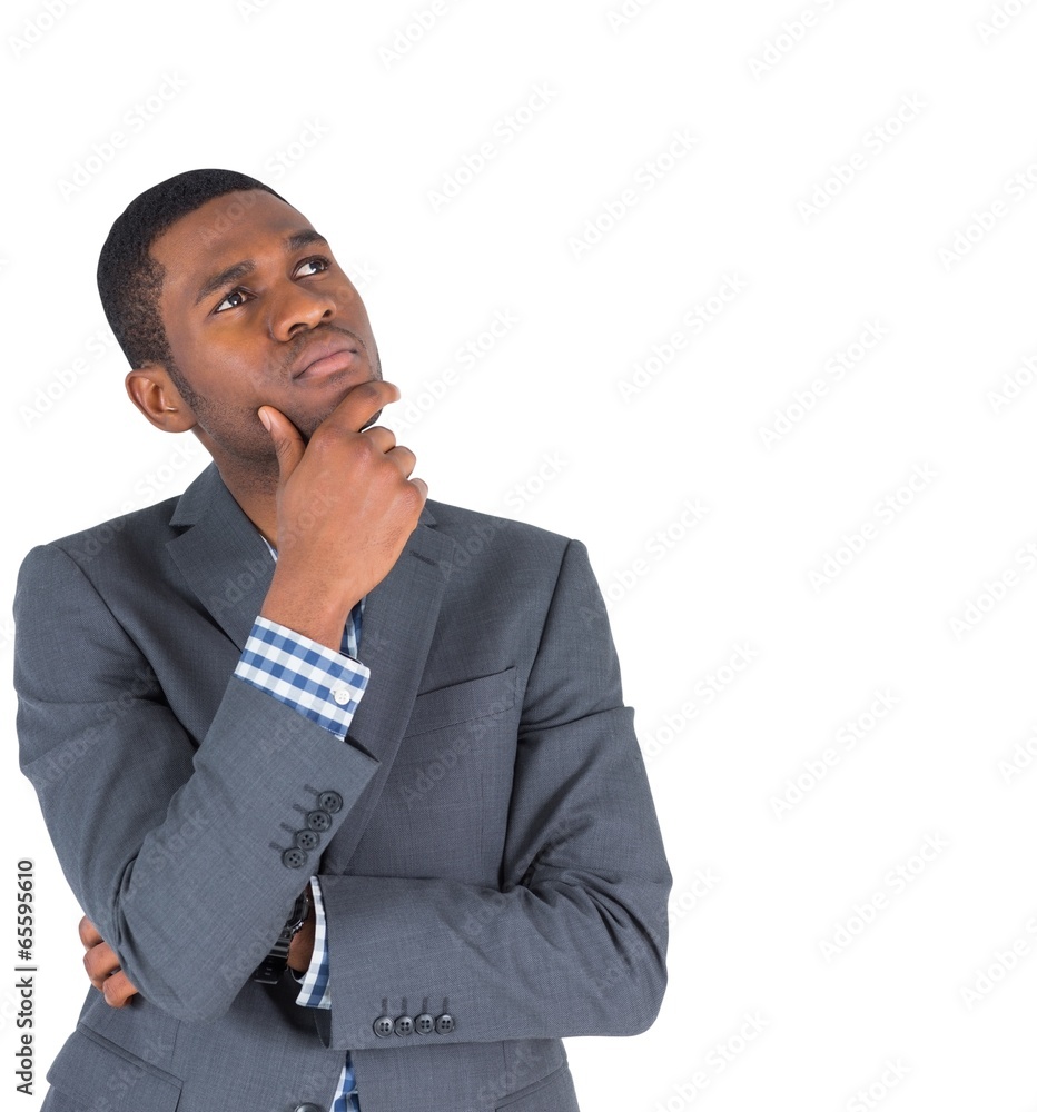 Thinking businessman standing with hand on chin Thinking businessman standing with hand on chin