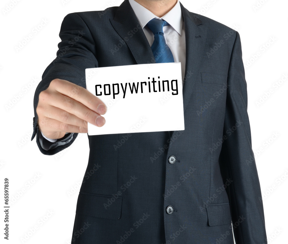 businessman holding a white sheet of paper with the inscription on white background: copywriting businessman holding a white sheet of paper with the inscription on white background: copywriting