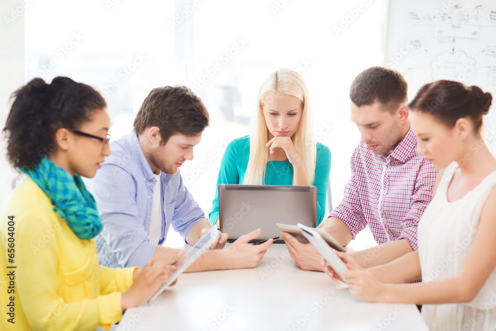 serious team with table pc and laptop in office serious team with table pc and laptop in office