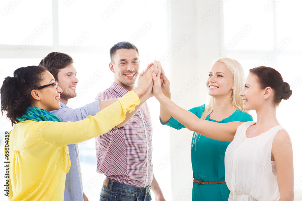 creative team doing high five gesture in office creative team doing high five gesture in office