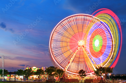 Amusement park at dusk - Ferris wheel in motion