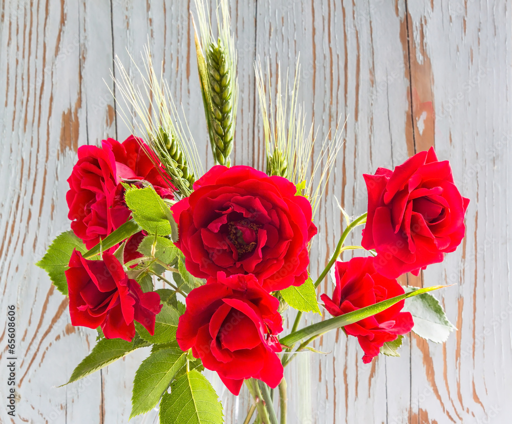 Bouquet of red roses with green ears of wheat Bouquet of red roses with green ears of wheat