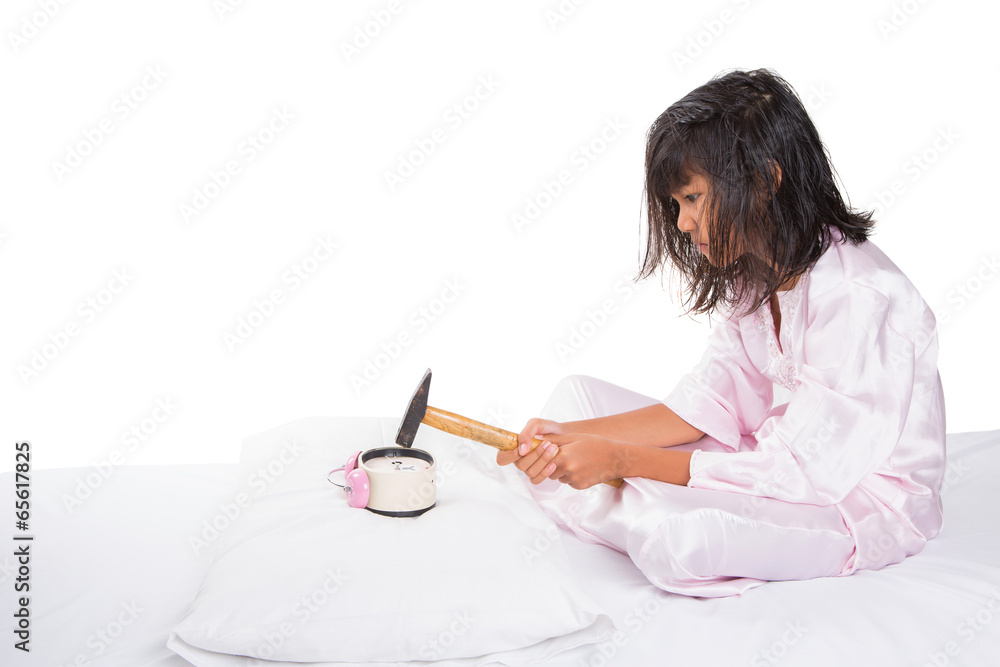 Irritated young girl waking up from sleep and destroy clock Irritated young girl waking up from sleep and destroy clock