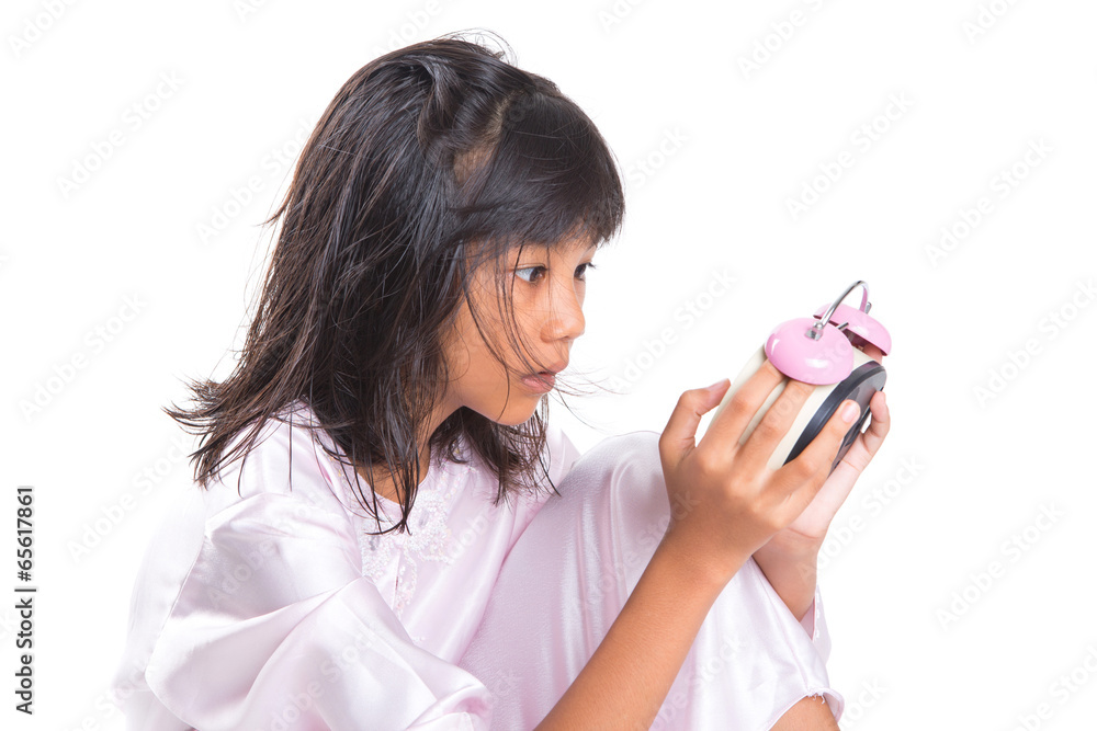 Concept image of young girl overslept checking time with a clock Concept image of young girl overslept checking time with a clock