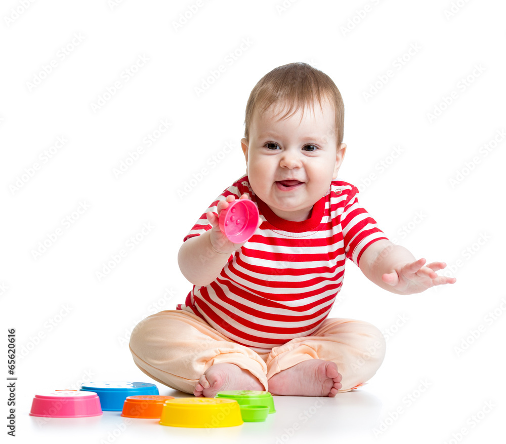 Funny little child is playing with toys while sitting on floor, Funny little child is playing with toys while sitting on floor,