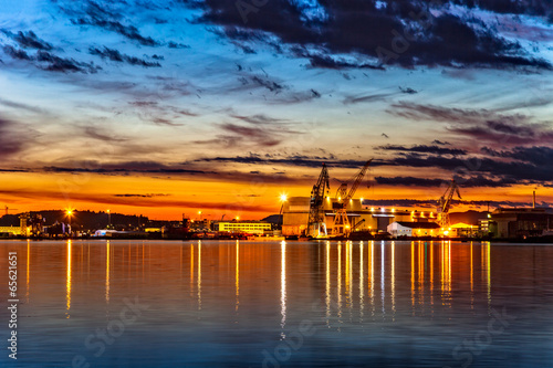 Sunset over an industry harbor with cranes in Stavanger, Norway. © Nightman1965