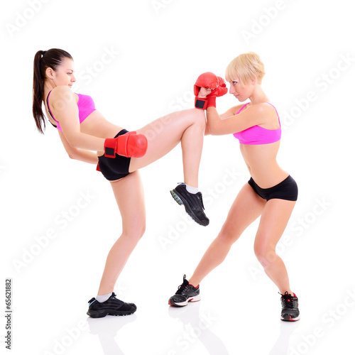 sport training of two boxing young woman, studio over white