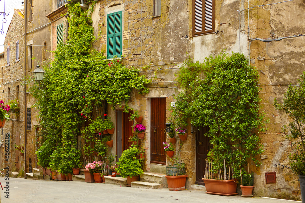 Vintage street decorated with flowers, Tuscany, Italy