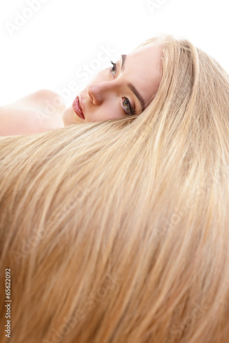 Hair. Beautiful bond girl with healthy long hair. Haicare and ha