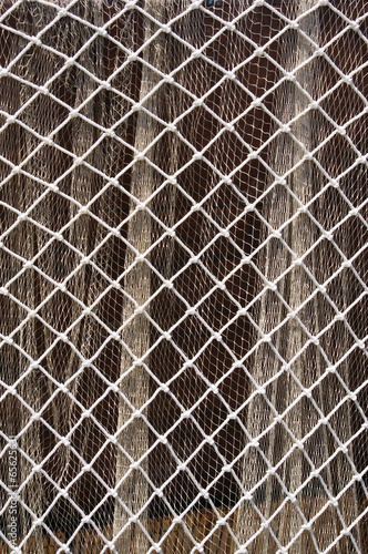 Two fishing nets on brown background