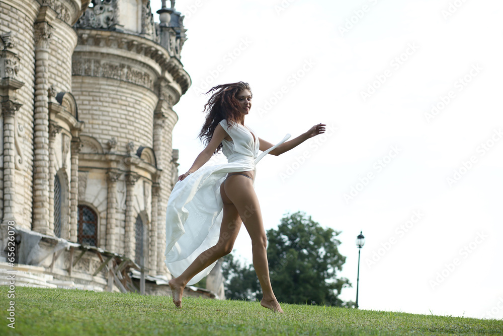 Young woman in a white long dress Young woman in a white long dress