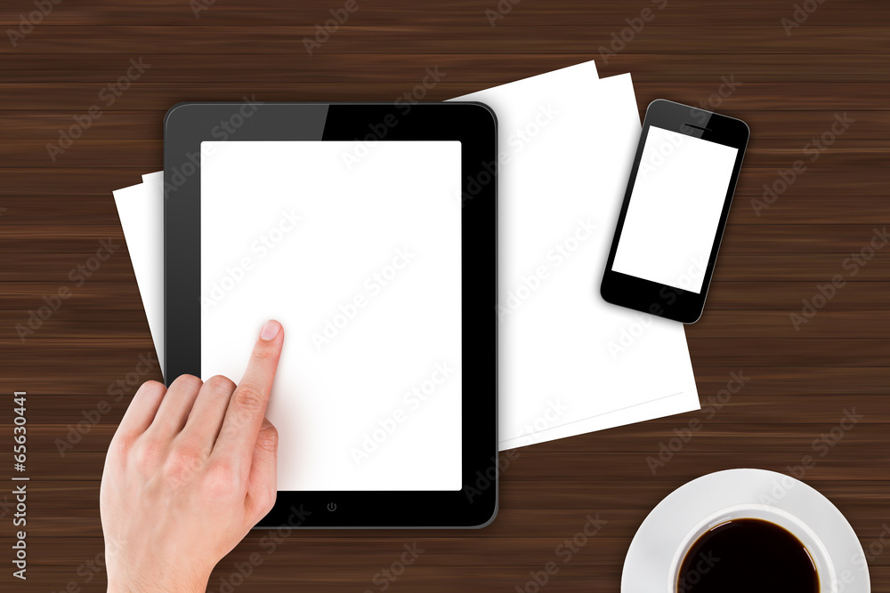 Hand Touching Digital Devices on Office Table Hand Touching Digital Devices on Office Table